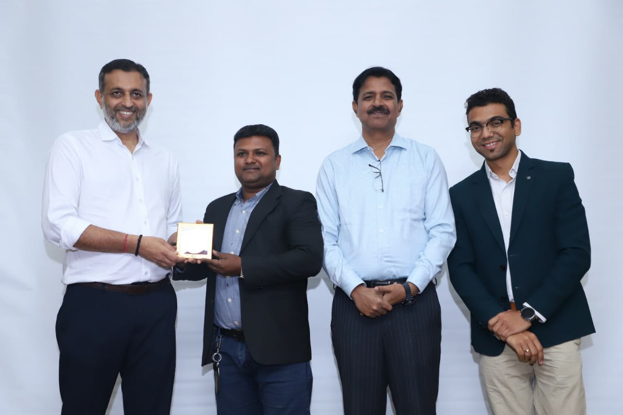 car interior from central back seat position showing driver and blurred view through windscreen of a busy road at night