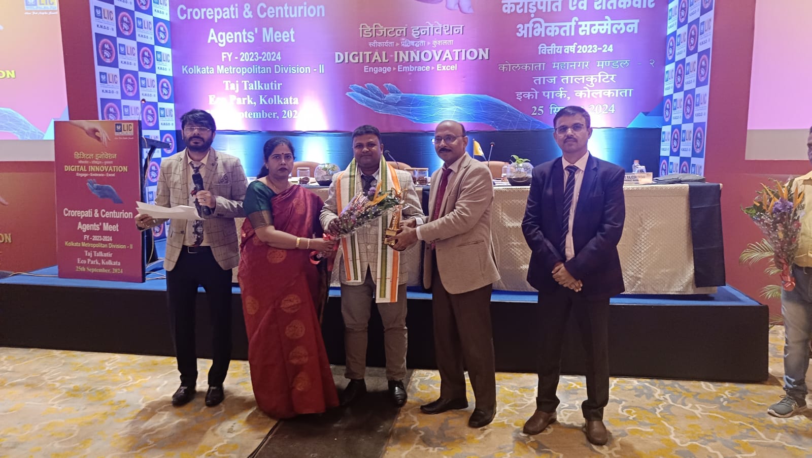 car interior from central back seat position showing driver and blurred view through windscreen of a busy road at night