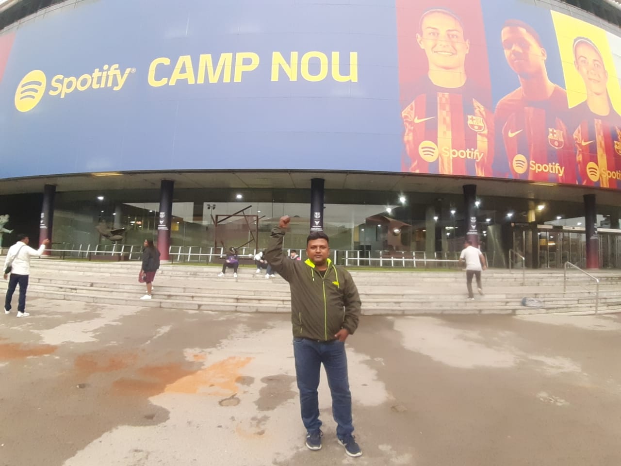 people holding umbrellas on a busy street at night lit by street lights and illuminated signs in Tokyo, Japan