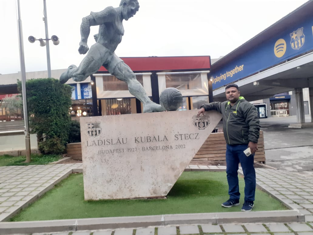 car interior from central back seat position showing driver and blurred view through windscreen of a busy road at night